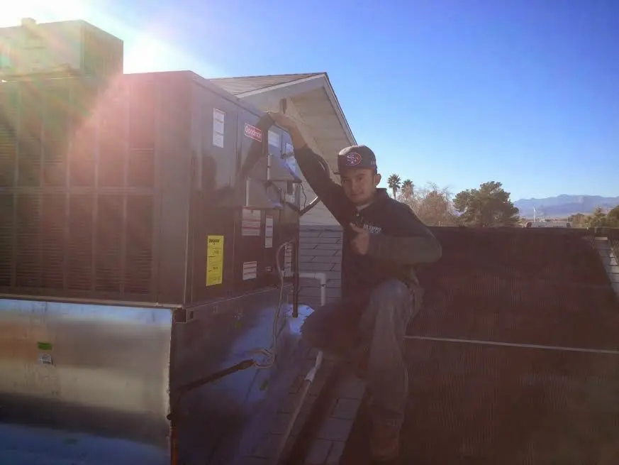 HVAC technician performing Air Duct Repair on a rooftop unit in Scotts Valley